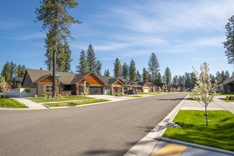 A row of new single story homes with garages on a suburban street in the city of Coeur d'Alene, Idaho