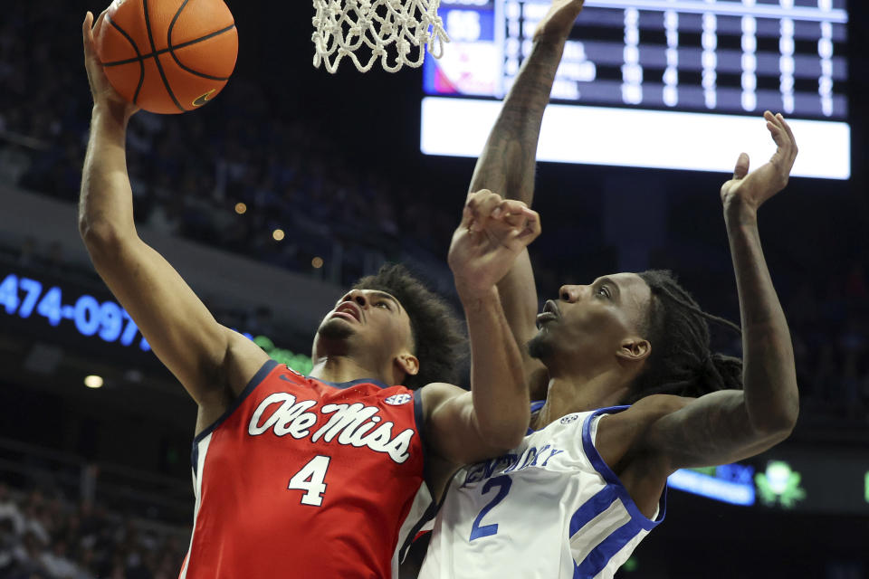 Mississippi's Jaemyn Brakefield (4) is pressured by Kentucky's Aaron Bradshaw, right, during the second half of an NCAA college basketball game Tuesday, Feb. 13, 2024, in Lexington, Ky. Kentucky won 75-63. (AP Photo/James Crisp)
