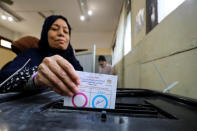 A woman casts her vote during the referendum on draft constitutional amendments, at a polling station in Cairo, Egypt April 20, 2019. REUTERS/Mohamed Abd El Ghany