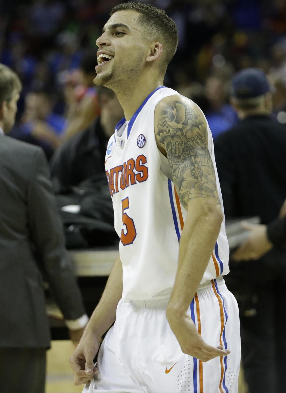 Florida guard Scottie Wilbekin (5) celebrates after the second half in a regional final game against Dayton at the NCAA college basketball tournament, Saturday, March 29, 2014, in Memphis, Tenn. Florida won 62-52. (AP Photo/Mark Humphrey)