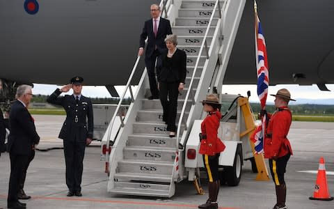 Prime Minister Theresa May and her husband Philip are greeted as they arrive at CAF Bagotville airfield  - Credit: Getty