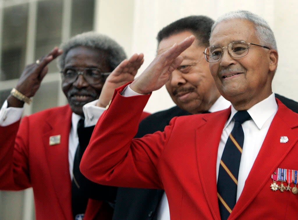 Tuskegee Airmen, Cicero Satterfield, left, Lucius Theus, center, and Charles McGee, right, salute while posing for a group photo on the steps of the Capitol during a ceremony kicking off a nationwide fundraising drive for a memorial to the Tuskegee Airmen, Monday Dec. 18, 2006, in Montgomery, Ala. (AP Photo/Rob Carr, File)