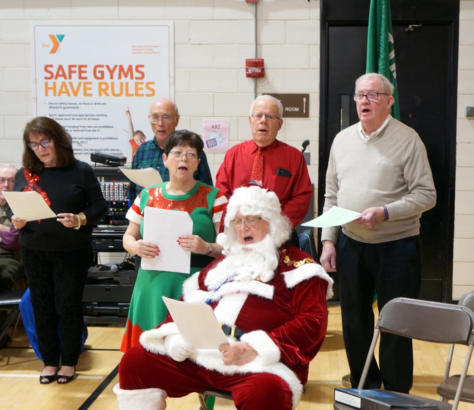 The club, soon to be renamed the Retired Friends of Greendale, has been a steady contributor to the T&G Santa over the years. At a Dec. 20 Christmas party at the Greendale YMCA, the club raised $1,500 for the fundraising effort. From left, back row, Cris McGee, Gerald LaGueux, Sandy Wreschinsky and Bob Chiarvalloti. At front are the Elf on the Shelf and Santa.
