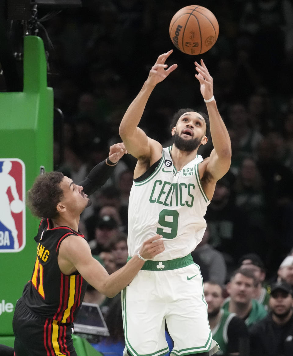 Boston Celtics guard Derrick White (9) grabs a loose ball against Atlanta Hawks guard Trae Young (11) during the second half of Game 2 in the first round of the NBA basketball playoffs, Tuesday, April 18, 2023, in Boston. (AP Photo/Charles Krupa)