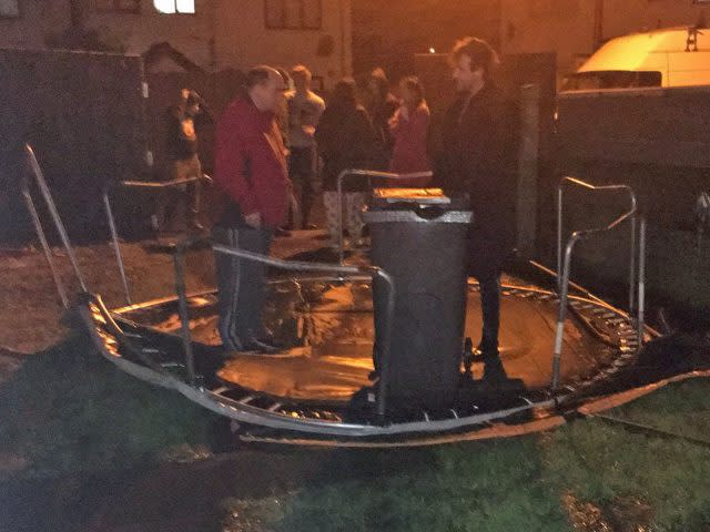 People hold down a trampoline in Carrickfergus, Northern Ireland 