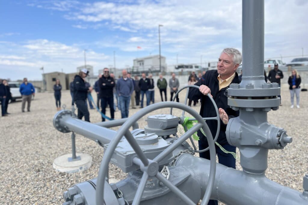 NorthWestern Energy CEO Brian Bird turns the valve at the company's new renewable natural gas injection site on April 22, 2024, in Brookings. (Joshua Haiar/South Dakota Searchlight)