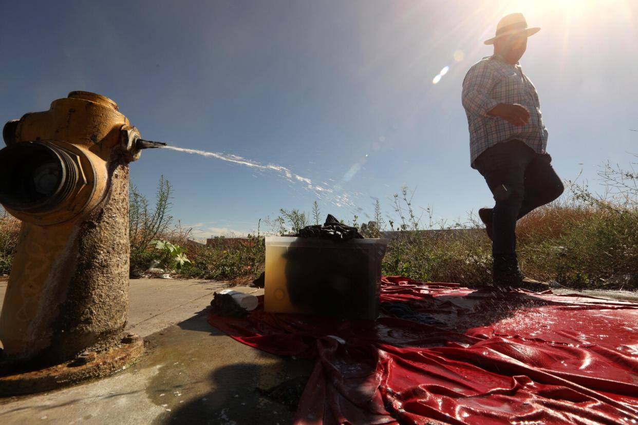 A man walking past a fire hydrant