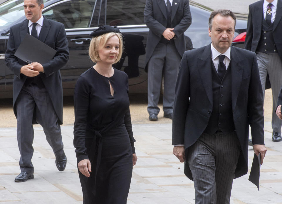 British Prime Minister Liz Truss and her husband Hugh O'Leary arrive for the funeral service of Queen Elizabeth II at Westminster Abbey in central London, Monday Sept. 19, 2022. The Queen, who died aged 96 on Sept. 8, will be buried at Windsor alongside her late husband, Prince Philip, who died last year. (Geoff Pugh/Pool via AP)