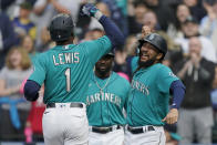 Seattle Mariners' Kyle Lewis (1) is greeted at the dugout by J.P. Crawford, right, after Lewis hit a two-run home run to score Crawford against the Houston Astros during the first inning of a baseball game Friday, May 27, 2022, in Seattle. (AP Photo/Ted S. Warren)