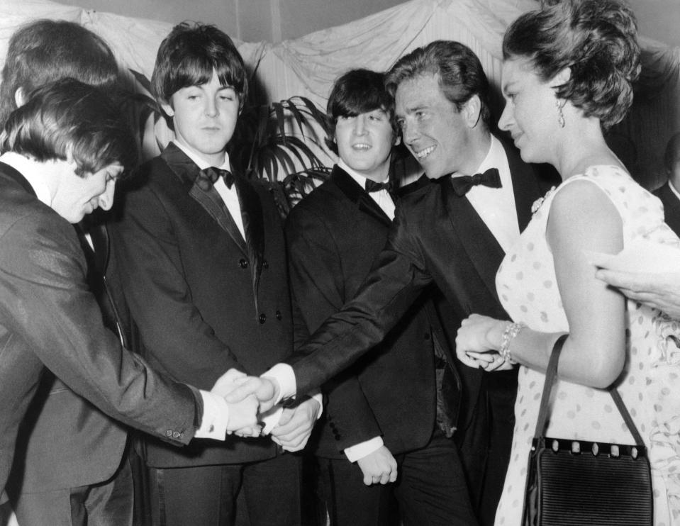 FILE - This is a July 29, 1965 file photo of Britain's Princess Margaret with Lord Snowdon, Anthony Armstrong Jones, 2nd left, as he shakes hands with Ringo Starr when meeting the Beatles before the world charity premiere of their second film, "Help", at the London Pavilion, in London. Lord Snowdon, the former husband of Princess Margaret who was also a photographer, has died. He was 86. Antony Armstrong-Jones, or Lord Snowdon, died peacefully at his home on Friday Jan. 13 2017.﻿﻿ ﻿ (AP Photo, File)