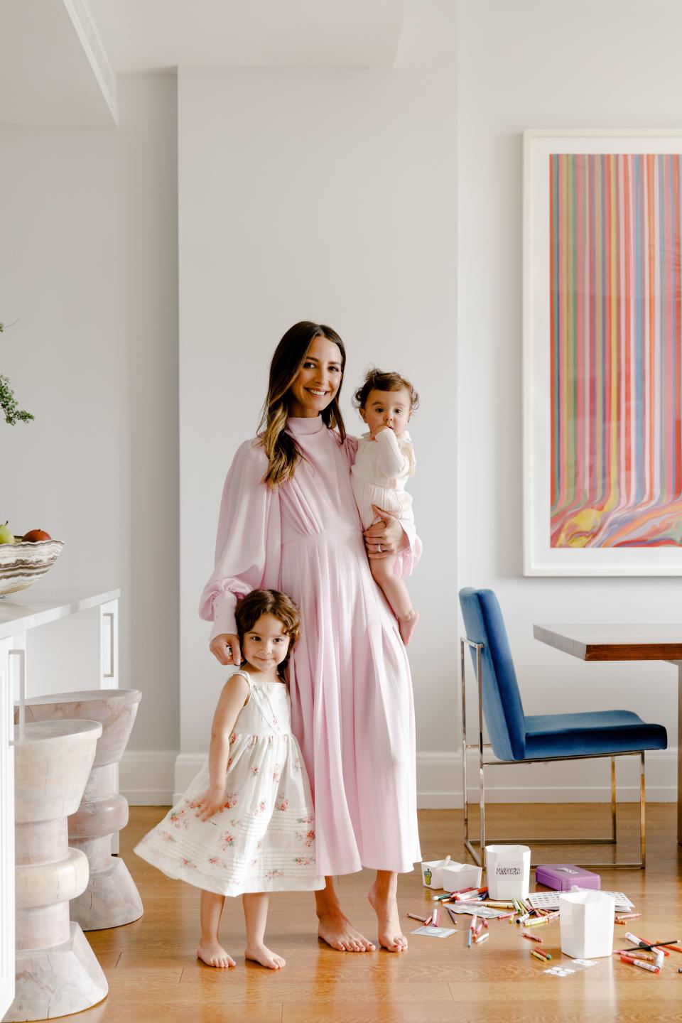 Charnas, pictured here in her dining room, with daughters Ruby and Esme.