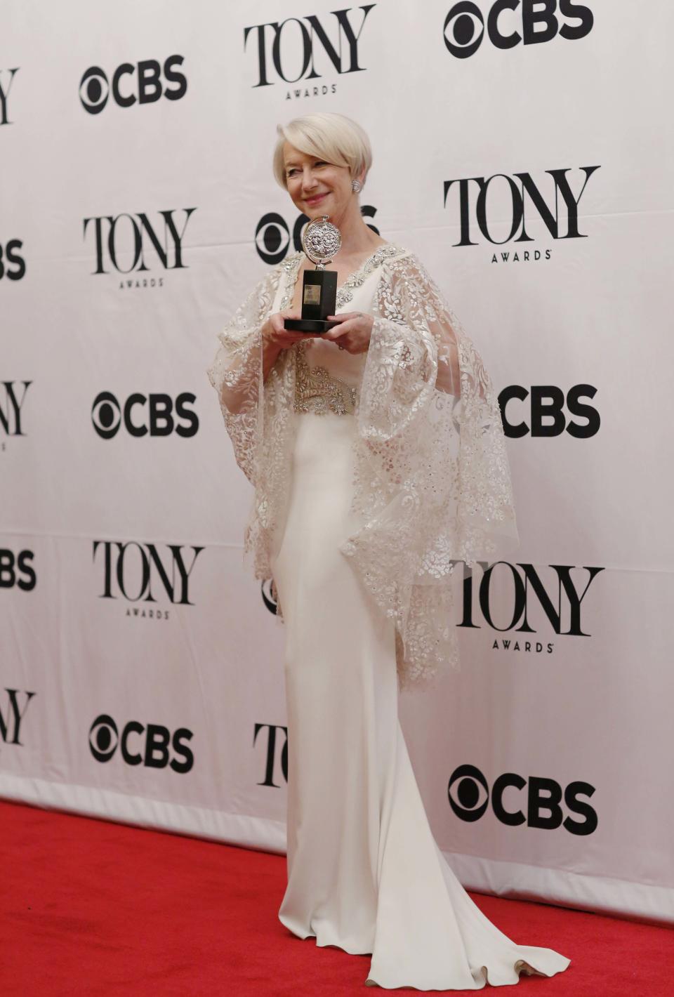 Helen Mirren poses backstage with her award for Best Performance By An Actress In A Leading Role In A Play for "The Audience" during the American Theatre Wing's 69th Annual Tony Awards at the Radio City Music Hall in Manhattan