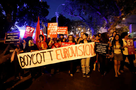 Protesters hold banners and placards as they take part in a demonstration calling for an end to Israel's policy towards Gaza and a boycott of the 2019 Eurovision Song Contest as the first semi final of the contest begins in Tel Aviv, Israel May 14, 2019. REUTERS/Corinna Kern