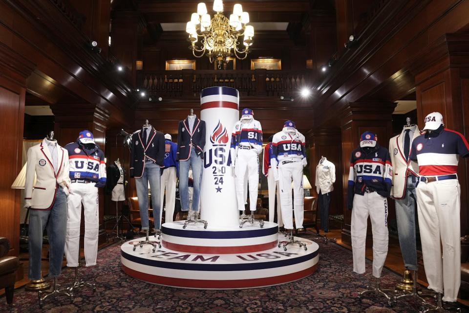 A formal showroom with mannequins in red, white and blue athletic outfits.