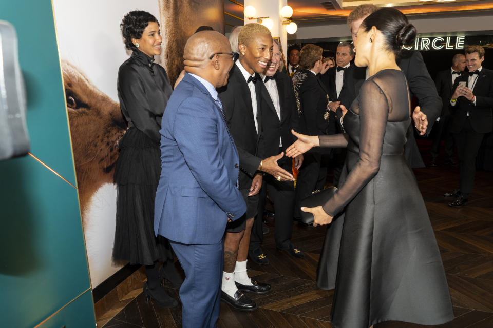 Meghan Markle shakes hands with Pharrell