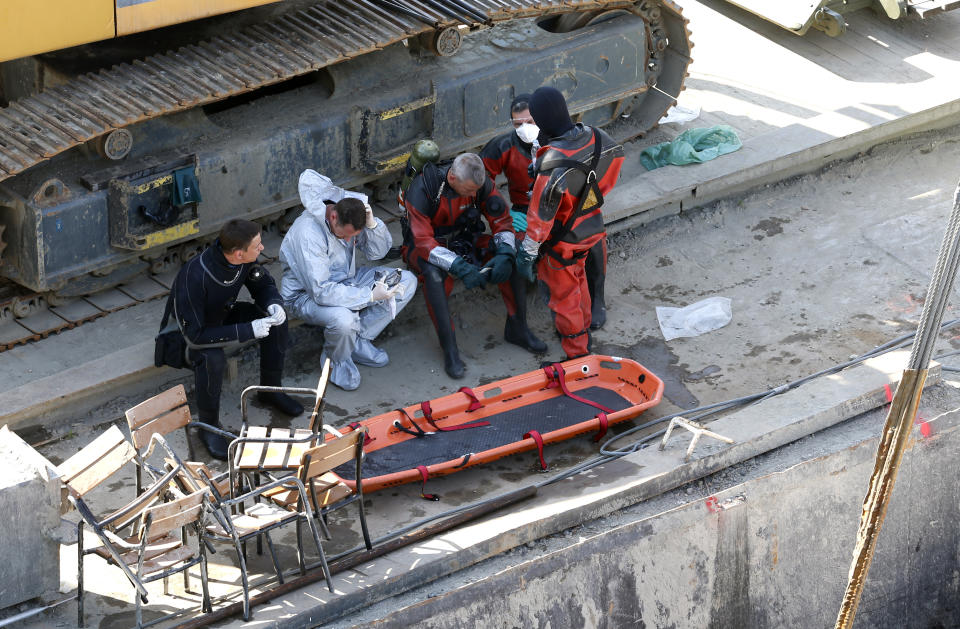 Rescuers rest on a huge floating crane under the Margit bridge, where the Hableany (Mermaid) sightseeing boat sank May 29 after colliding with a much larger river cruise ship in Budapest, Hungary, Tuesday, June 11, 2019. Eight people are still missing from the May 29 collision between the Hableany (Mermaid) sightseeing boat and the Viking Sigyn river cruise ship at Budapest's Margit Bridge. (AP Photo/Darko Bandic)