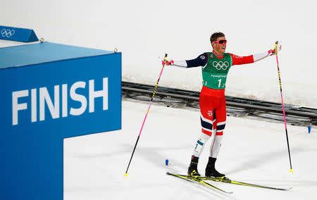 Cross-Country Skiing - Pyeongchang 2018 Winter Olympics - Men's Team Sprint Free Finals - Alpensia Cross-Country Skiing Centre - Pyeongchang, South Korea - February 21, 2018. Johannes Hoesflot Klaebo of Norway celebrates winning gold. REUTERS/Kai Pfaffenbach