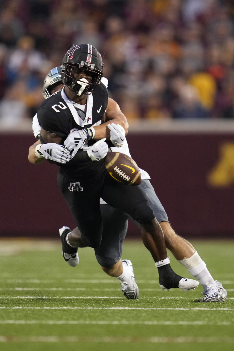 Minnesota running back Sean Tyler fumbles the football while tackled by Eastern Michigan linebacker Zach Mowchan during the first half of an NCAA college football game Saturday, Sept. 9, 2023, in Minneapolis. The fumble would go out of bounds and remain Minnesota possession. (AP Photo/Abbie Parr)