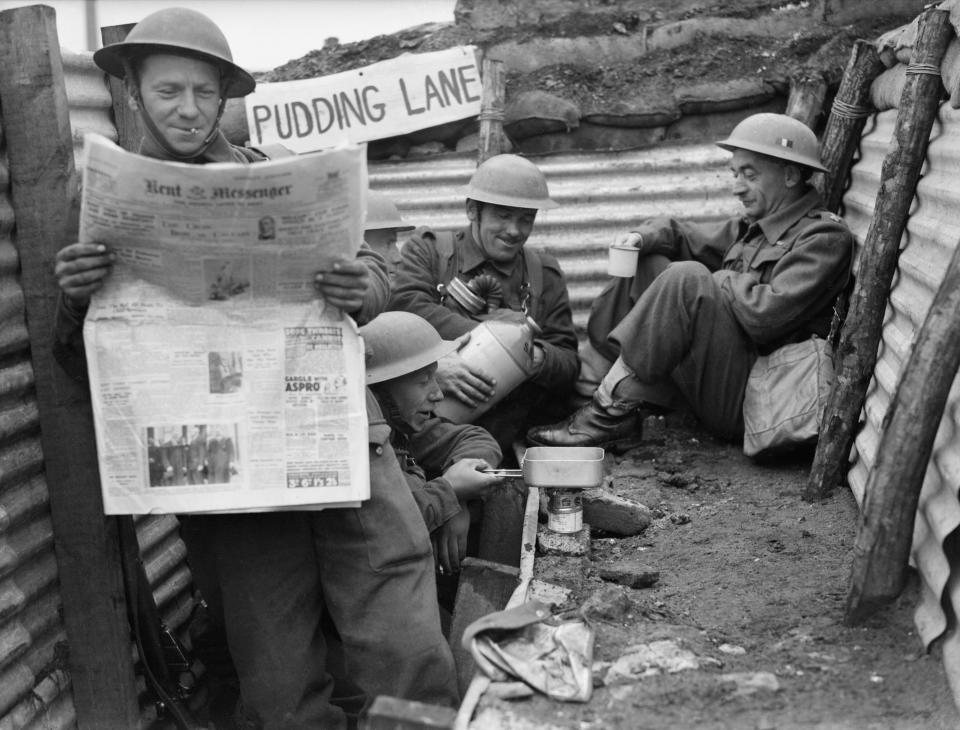 The British Army In France 1940, Men of the 1st Queen's Own Royal West Kent Regiment enjoy a tot of rum in a section of trench named 'Pudding Lane,' 4th Division near Roubaix, 3 April 1940.