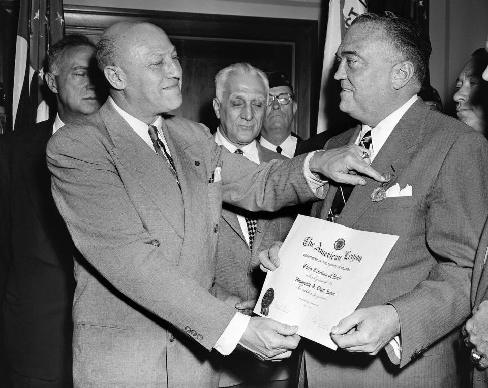 FBI Director J. Edgar Hoover is presented an award in 1953