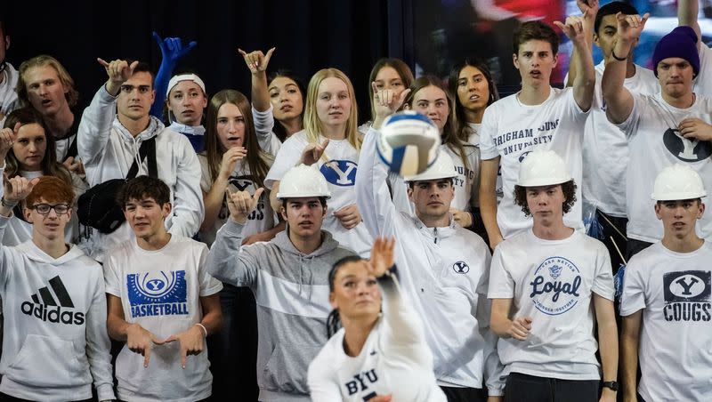 BYU student fans watch as Whitney	Bower serves the ball against Utah in an NCAA volleyball game at Smith Fieldhouse in Provo on Saturday, Dec. 4, 2021. Bower has been the Cougars’ starting setter ever since graduating high school a year early and joining the team in 2019 as a 17-year-old freshman