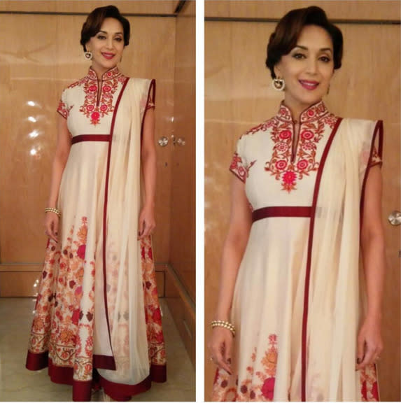 Madhuri cuts a pretty picture in this Rohit Bal outfit. Her move to tie her hair in a retro style made sure the earrings get all the attention and take her look up a notch.