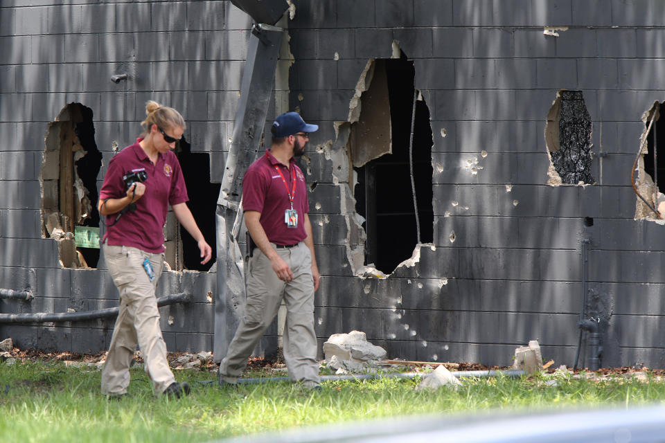 <p>Investigators from the office of the medical examiner investigate on the west side of Pulse nightclub where a gunman opened fire on Sunday morning, June 12, 2016, in Orlando, Fla. (Doug Clifford/The Tampa Bay Times via AP) </p>