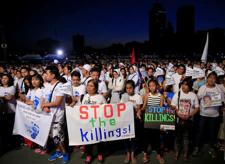 Participants display placards as they participate in a procession against plans to reimpose death penalty and intensify drug war during "Walk for Life" in Luneta park, Metro Manila, Philippines February 24, 2018. REUTERS/Romeo Ranoco