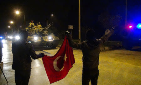 Villagers greet Turkish troops as they arrive at a border village near Hassa in Hatay province, Turkey, January 20, 2018. Picture taken January 20, 2018. Ramazan Celik/Dogan News Agency via REUTERS