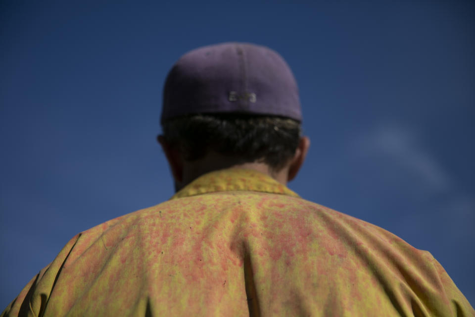 Wearing a shirt stained with fire retardant, firefighter Ryan O'Neill listens to U.S. Secretary of the Interior Ryan Zinke at decimated Paramount Ranch Thursday, Nov. 15, 2018, in Agoura Hills, Calif. The landmark film location burned to the ground by the Woolsey Fire. (AP Photo/Jae C. Hong)