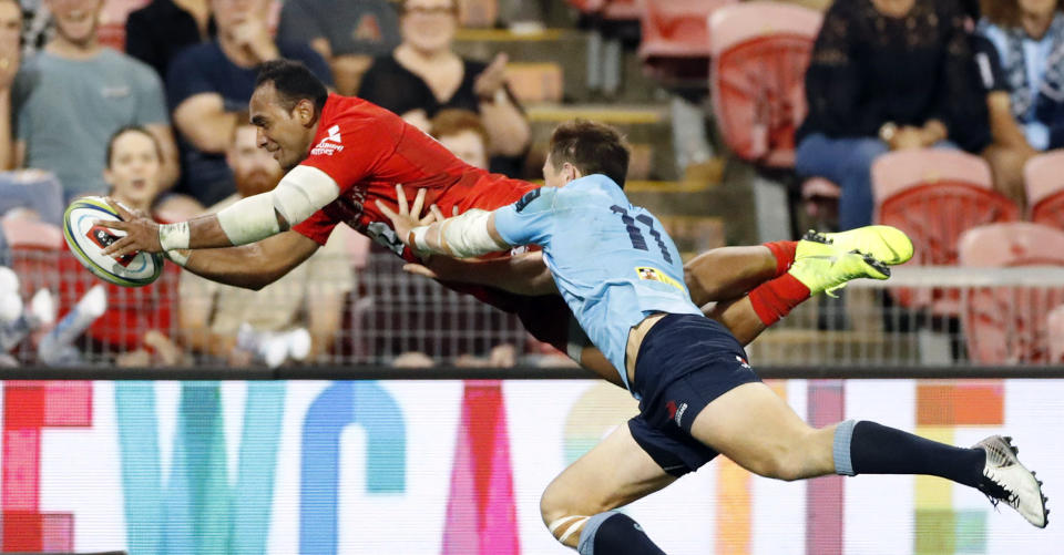 Semisi Masirewa, left, of Sunwolves scores a try during the Round 7 Super Rugby match against the New South Wales Waratahs in Newcastle, Australia Friday, March 29, 2019 (Naoya Osato/Kyodo News via AP)