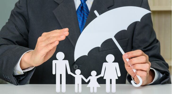 Businessman protecting family