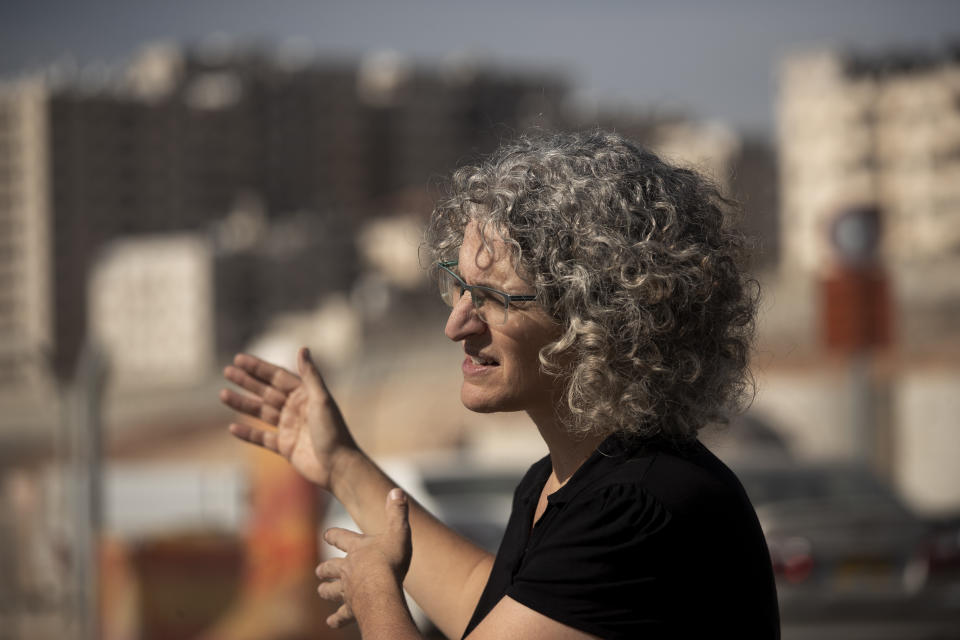 Hagit Ofran of the watchdog group Peace Now, speaks during an interview where Israel is moving ahead with plans to build a massive Jewish settlement on the site of a long-abandoned airport that the Palestinians had hoped would one day service their future capital in east Jerusalem, Wednesday, Nov. 24, 2021. (AP Photo/Maya Alleruzzo)