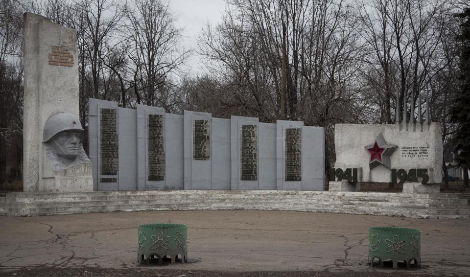 In this photo taken Tuesday, Feb. 25, 2014, a monument for World War Two victims is seen near the entrance of a coal mine in the outskirts of Donetsk, eastern Ukraine. If Ukraine looks neatly delineated on maps, its history is a tangle of invasions and occupations and peoples and religions, a place of ill-defined borders that for centuries has been struggling to define itself. The modern nation is so sharply divided by culture and loyalty, split between allegiance to Moscow and allegiance to Western Europe, that it often can appear ready to simply snap in two. (AP Photo/Darko Bandic)