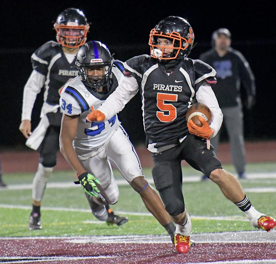 Oxford's Jordan Deleon turns the corner on KIPP Academy's Osaru Evbenaye.