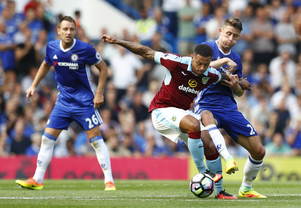 Football Soccer Britain - Chelsea v Burnley - Premier League - Stamford Bridge - 27/8/16 Burnley's Andre Gray in action with Chelsea's Gary Cahill as John Terry looks on Reuters / Eddie Keogh Livepic EDITORIAL USE ONLY. No use with unauthorized audio, video, data, fixture lists, club/league logos or "live" services. Online in-match use limited to 45 images, no video emulation. No use in betting, games or single club/league/player publications. Please contact your account representative for further details.