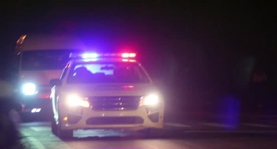 A police car seen with sirens and flashing lights. 