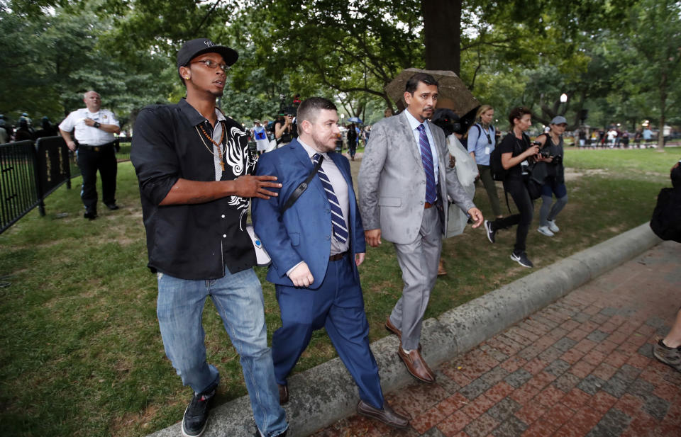Law enforcement escorts white nationalist leader Jason Kessler from the rally near the White House. (AP Photo/Alex Brandon)