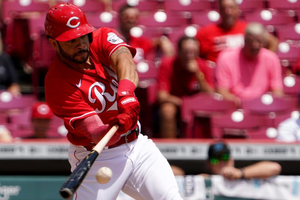 Cincinnati Reds left fielder Tommy Pham (28) hits a one-run double during the first inning of a baseball game against the Miami Marlins, Thursday, July 28, 2022, at Great American Ball Park in Cincinnati. 