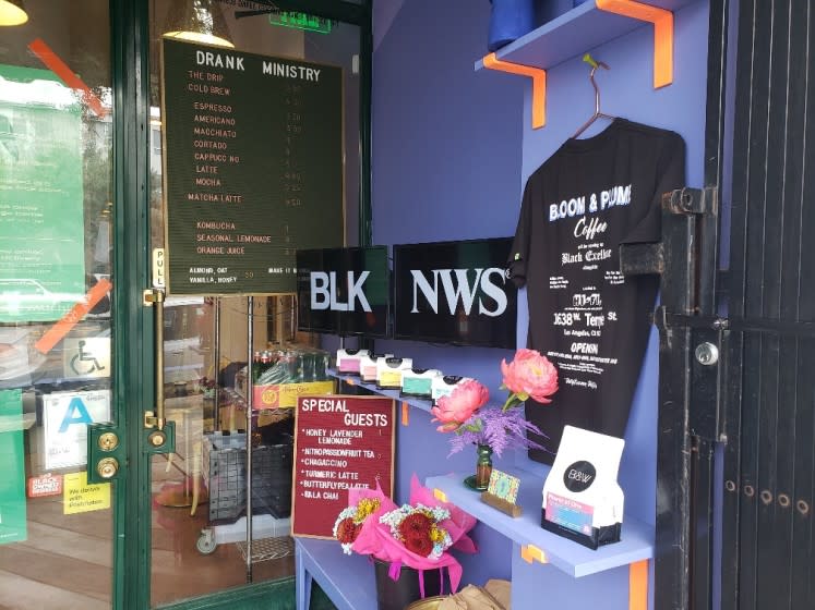 Kahlil Joseph's BLKNWS® plays on a pair of screens at a coffee shop in Historic Filipinotown