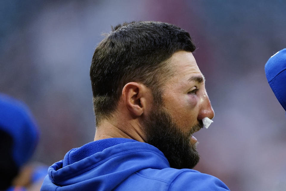 New York Mets' Kevin Pillar stands for the national anthem before the team's baseball game against the Atlanta Braves on Tuesday, May 18, 2021, in Atlanta. Pillar was hit on the face with a Jacob Webb fastball the night before. (AP Photo/John Bazemore)
