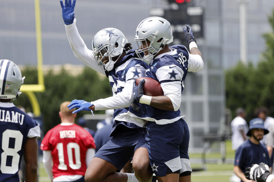 Dallas Cowboys cornerback Trevon Diggs, left, celebrates with Micah Parsons, right, after Parsons made an interception during NFL football practice in Frisco, Texas, Thursday, June 3, 2021. (AP Photo/Michael Ainsworth)