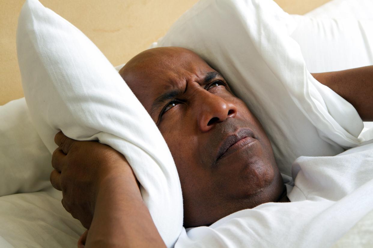 Man can't sleep holding a pillow over his ears