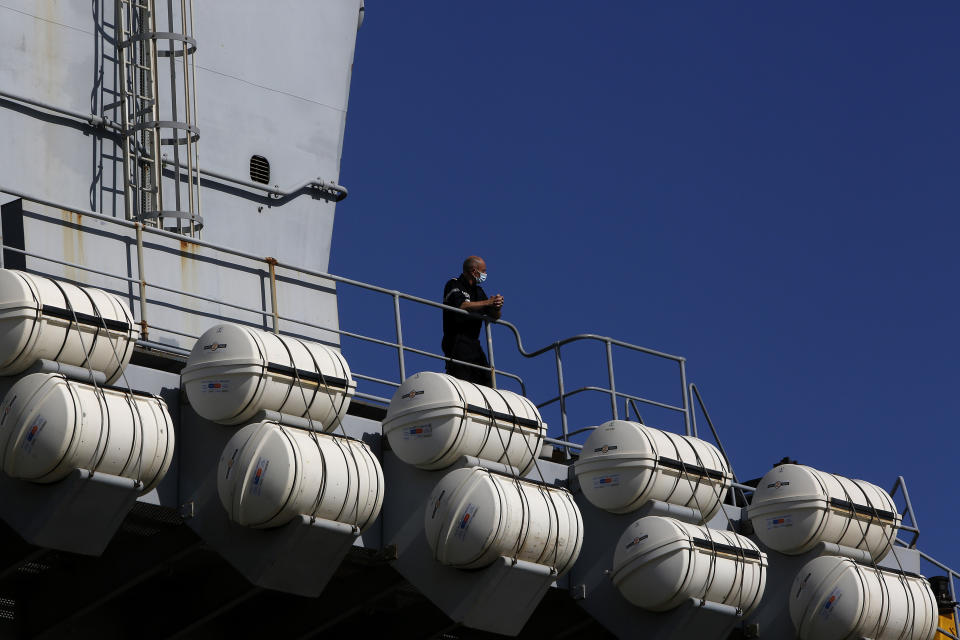 A French crew member stands at France's nuclear-powered aircraft carrier Charles de Gaulle in Limassol port, Cyprus, Monday, May 10, 2021. With the Task Force's deployment on its mission named "Clemenceau 21," France is assisting in the fight against terrorism while projecting its military power in regions where it has vital interests. (AP Photo/Petros Karadjias)