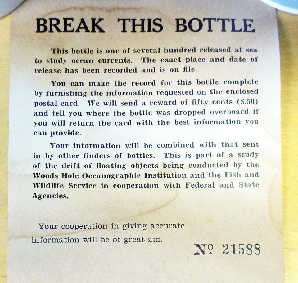 This January 2014 photo released by the Woods Hole Oceanographic Institution on Cape Cod, Massachusetts, shows a message found inside a glass bottle recovered on Sable Island, Nova Scotia, by biologist Warren N. Joyce of Canada's Department of Fisheries and Oceans. The bottle was among thousands dumped in the Atlantic Ocean between 1956 and 1972 as part of a program by Woods Hole oceanographer Dean Bumpus to study surface and bottom currents. About 10 percent of the 300,000 drift bottles have been found over the years. (AP Photo/Warren N. Joyce)