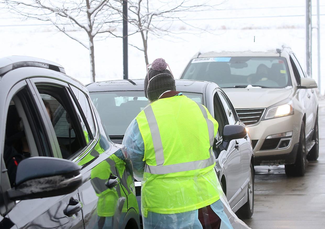 Workers often conduct drive-through COVID testing in parking lots. In this Times-Reporter file photo, testing was being done in the parking lot of the Ohio Star Theater.