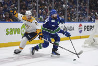 Vancouver Canucks' Filip Hronek (17) shoots the puck down the ice away from Nashville Predators' Filip Forsberg (9) during the second period in Game 1 of an NHL hockey Stanley Cup first-round playoff series in Vancouver, British Columbia, on Sunday, April 21, 2024. (Darryl Dyck/The Canadian Press via AP)