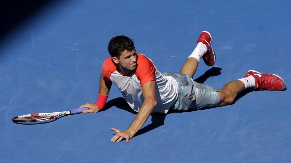 Grigor Dimitrov of Bulgaria lies on the court between points as he plays Rafael Nadal of Spain during their quarterfinal at the Australian Open tennis championship in Melbourne, Australia, Wednesday, Jan. 22, 2014. (AP Photo/Aijaz Rahi)