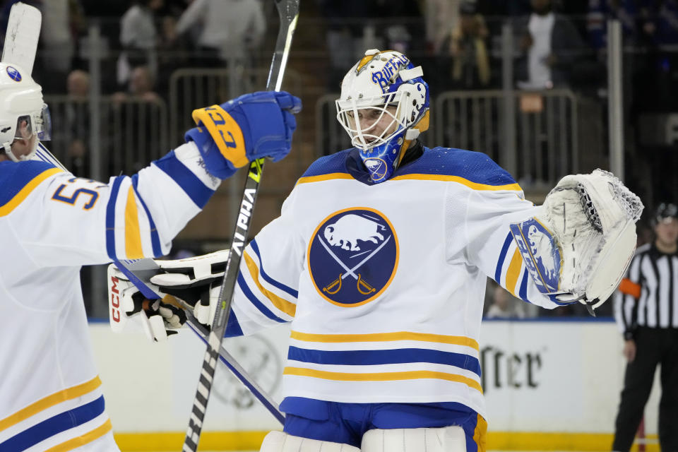 Buffalo Sabres goaltender Devon Levi, right, celebrates with left wing Jeff Skinner (53) after making the game-winning save against New York Rangers right wing Kaapo Kakko (24) during the overtime shootout period of an NHL hockey game, Monday, April 10, 2023, in New York. (AP Photo/John Minchillo)