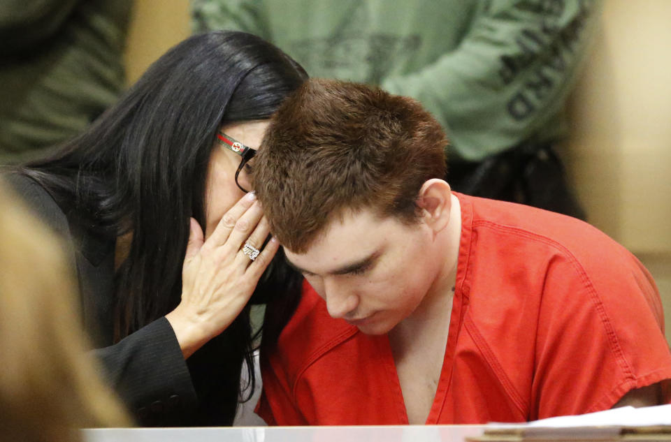 Assistant Public Defender Erin Veit, left, talks with school shooting suspect Nikolas Cruz sits in a Broward County courtroom for a hearing in Fort Lauderdale, Fla., Friday, Aug. 3, 2018. Attorneys for Cruz want a judge to prevent release of details of his education records to guarantee a fair trial. Cruz faces the death penalty if convicted of killing 17 people in the Valentine's Day attack at Marjory Stoneman Douglas High School. (AP Photo/Wilfredo Lee, Pool)